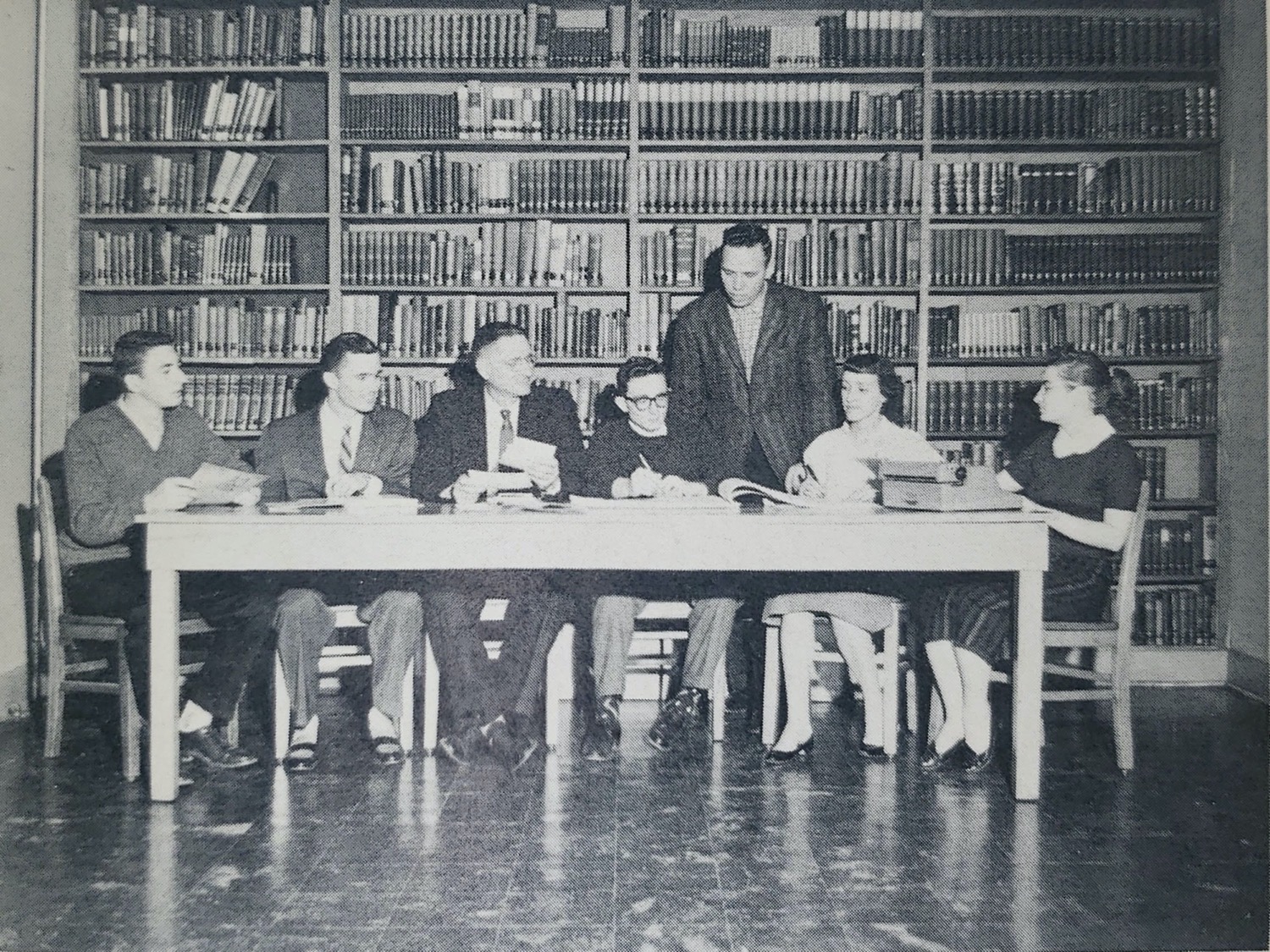 People in library sitting at table